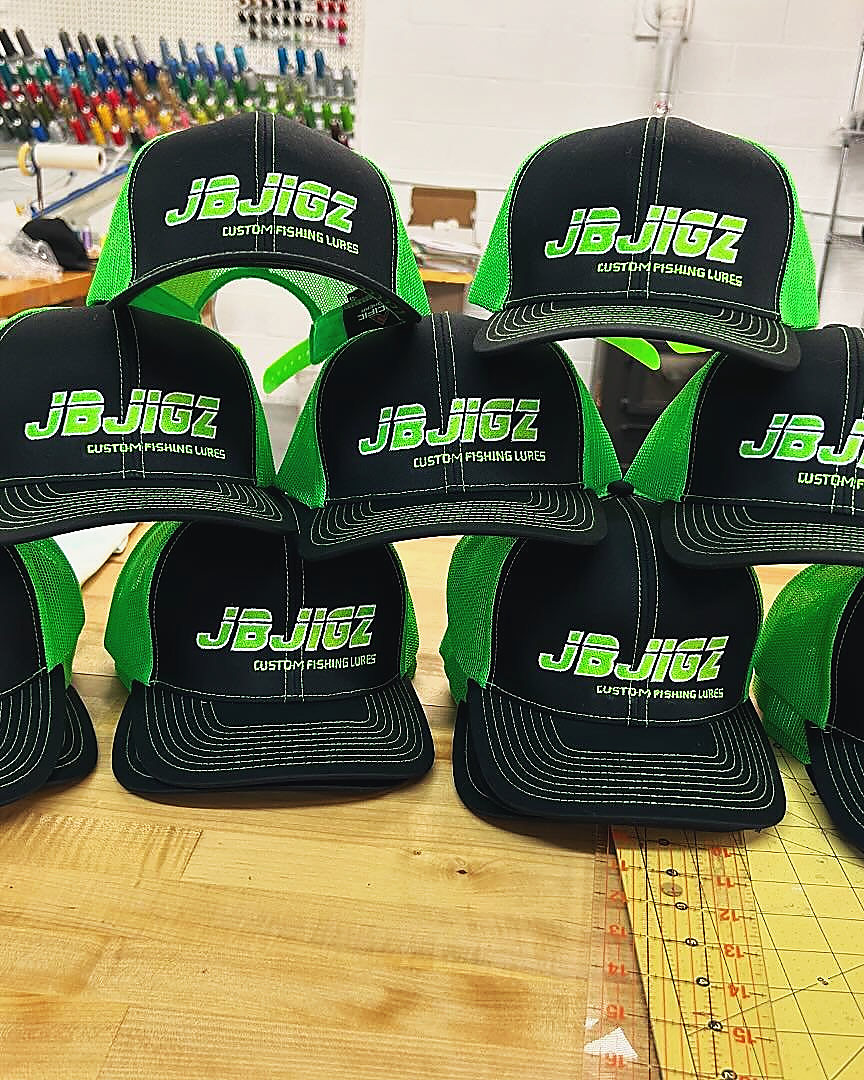 A stack of JB Jigz Custom Fishing Lures caps